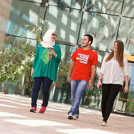 students walking across CMU Qatar's campus